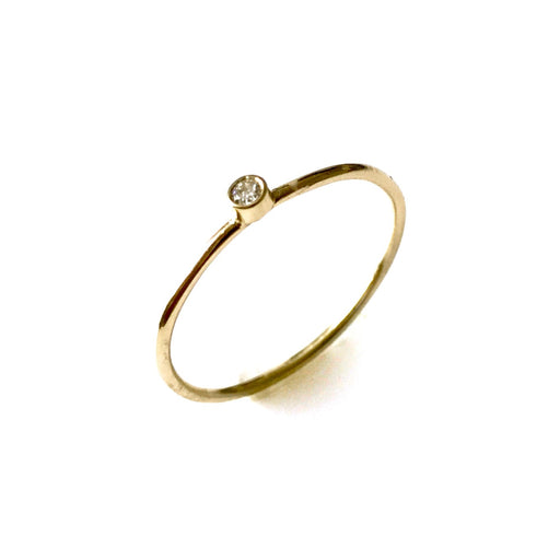 Close-up of 2mm round diamond bezel set in 9ct yellow gold solitaire ring