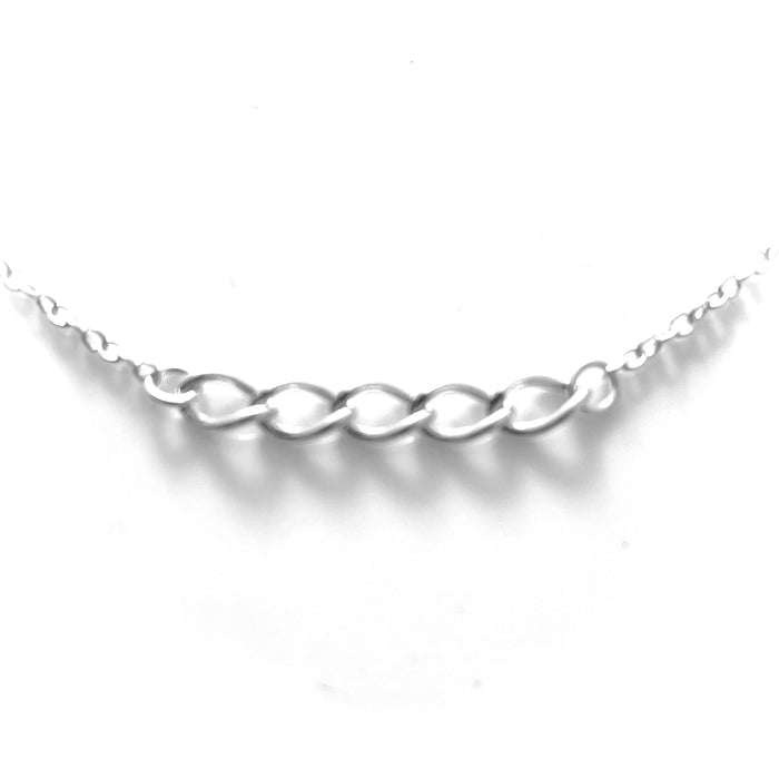Lustrous sterling silver mixed chain necklace elegantly laid against a pristine backdrop.