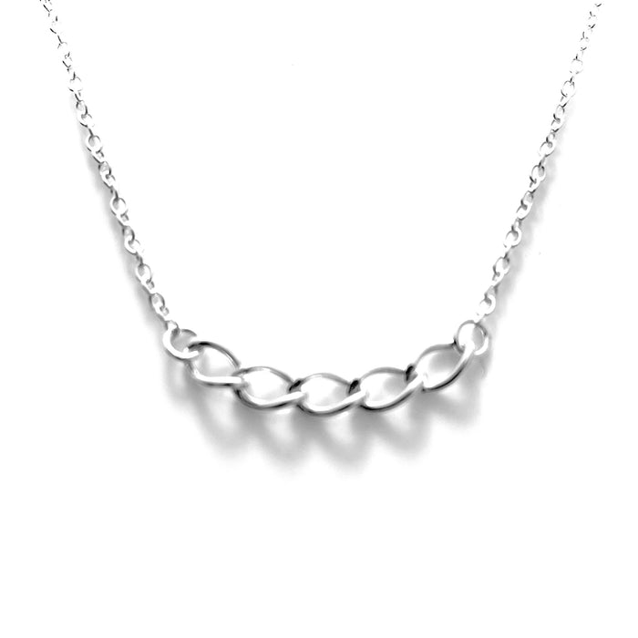 Artistic side angle of the curb chain pendant, showcasing its meticulous design and silvery gleam