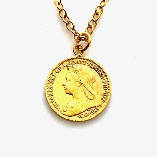 Close-up of 18ct gold plated 1900 threepence coin pendant