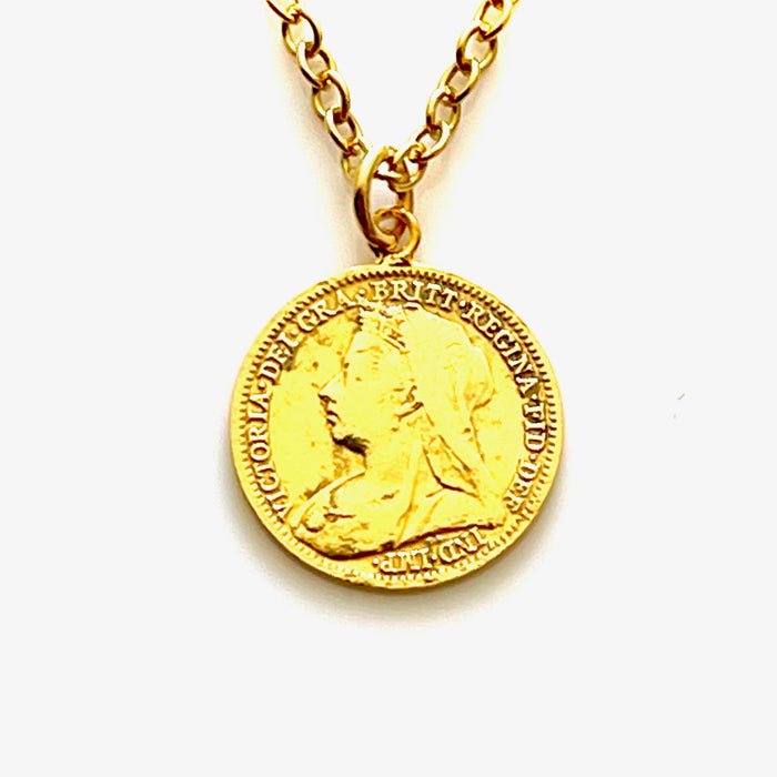 Close-up of 18ct gold plated 1901 Victorian threepence coin pendant