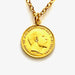 Close-up of vintage gold plated 1905 threepence coin pendant